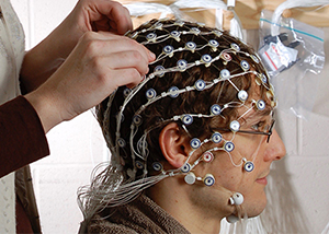 researcher applying a head net to a subject