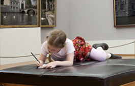 girl drawing in a museum