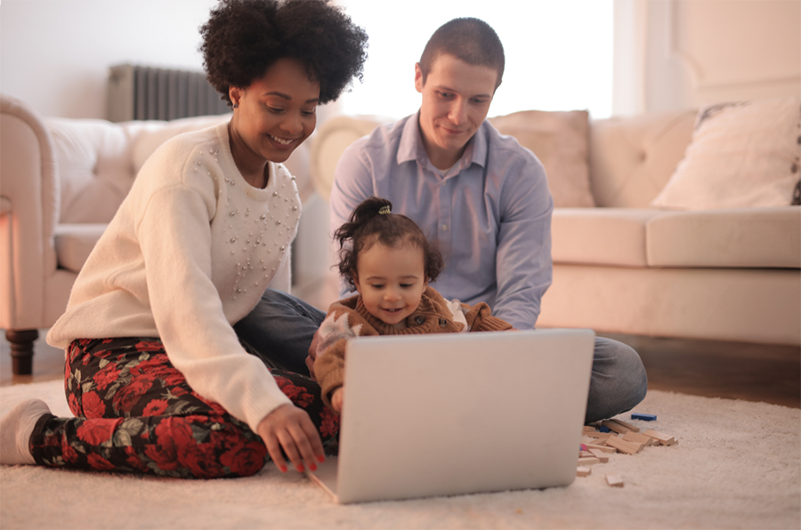 adults with child at laptop
